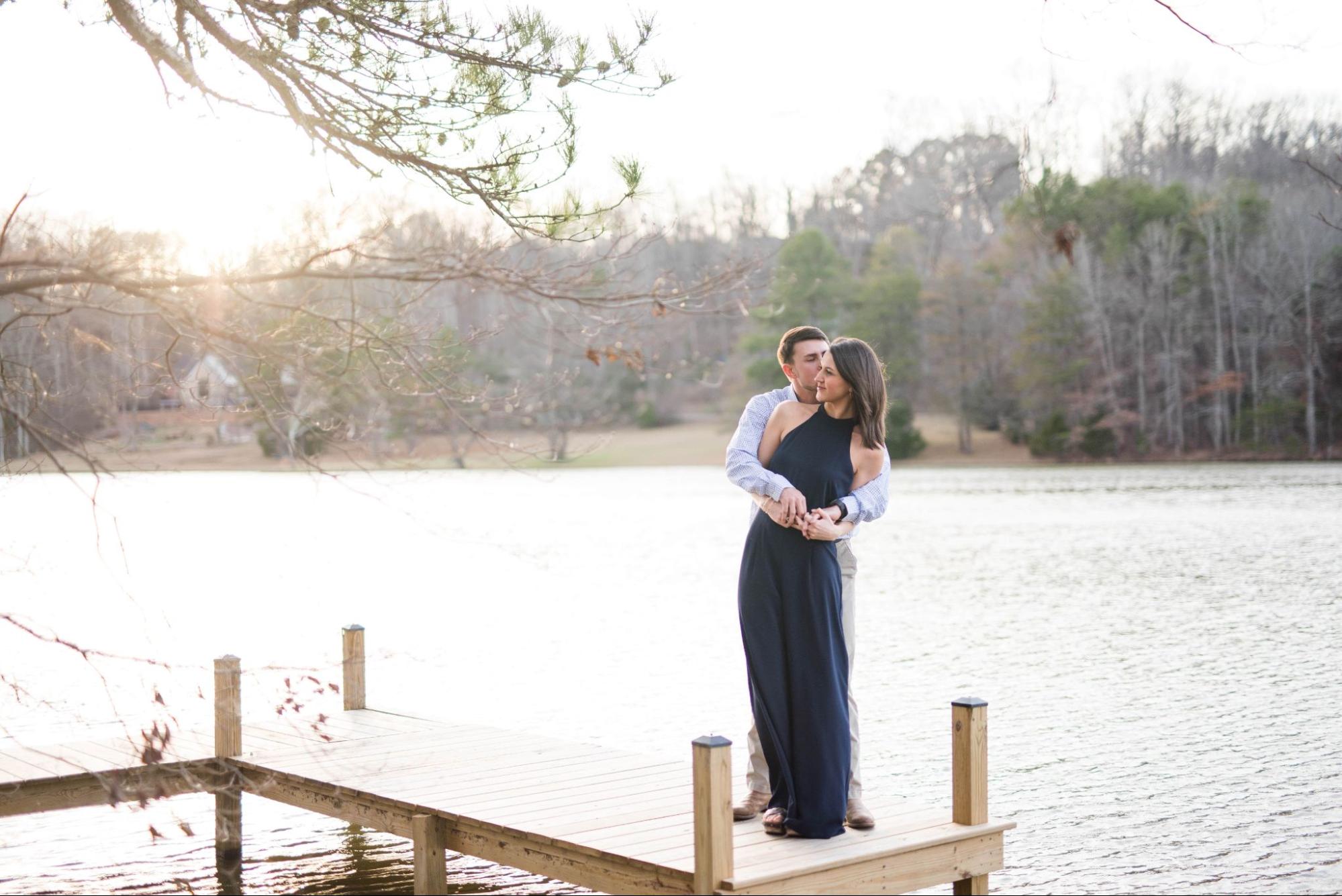 couple holding each other at edge of dock