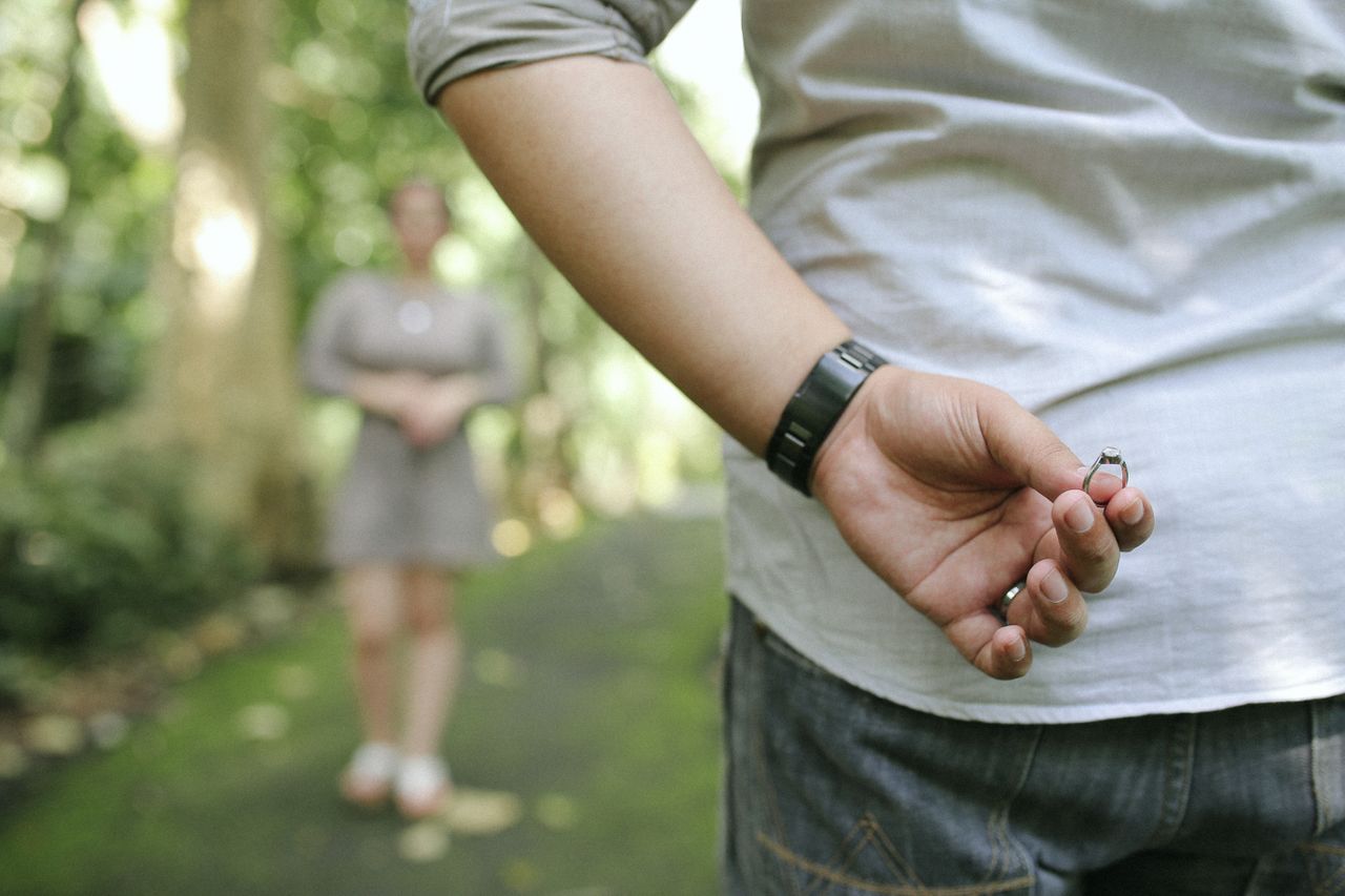 hiding engagement ring behind back