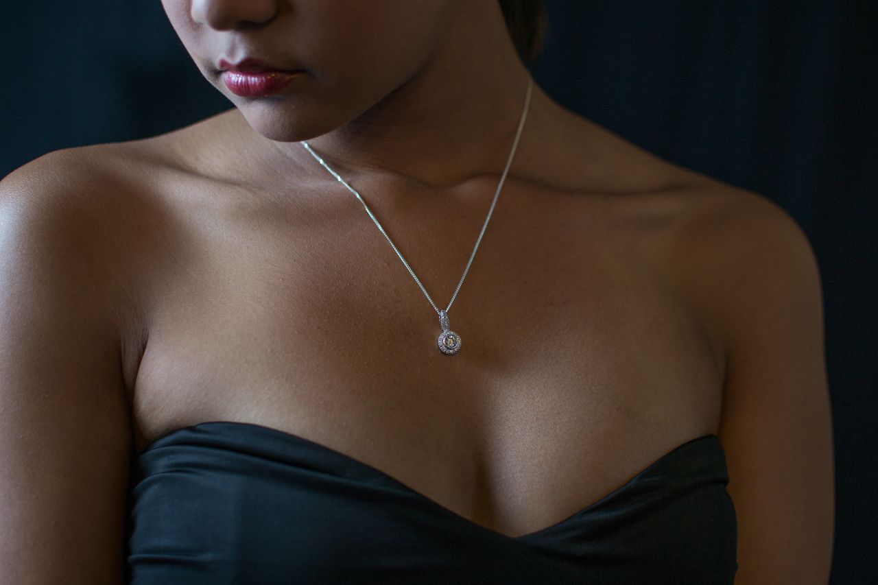 a lady wearing a diamond pendant