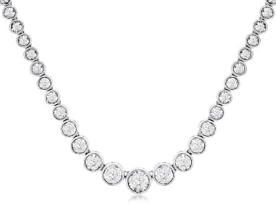 A tennis necklace features white gold and bezel-set diamonds.