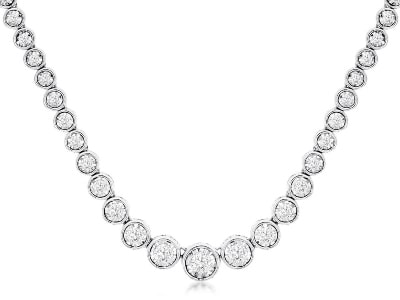 A tennis necklace features white gold and bezel-set diamonds.
