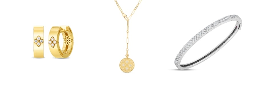A trio of Roberto Coin’s signature style of jewelry, including hoop earrings, a medallion pendant, and a diamond bangle.