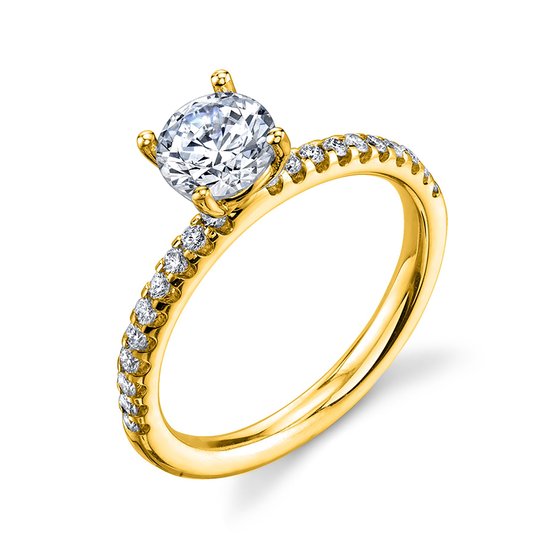 A yellow gold side stone engagement ring with round cut diamond as a center stone