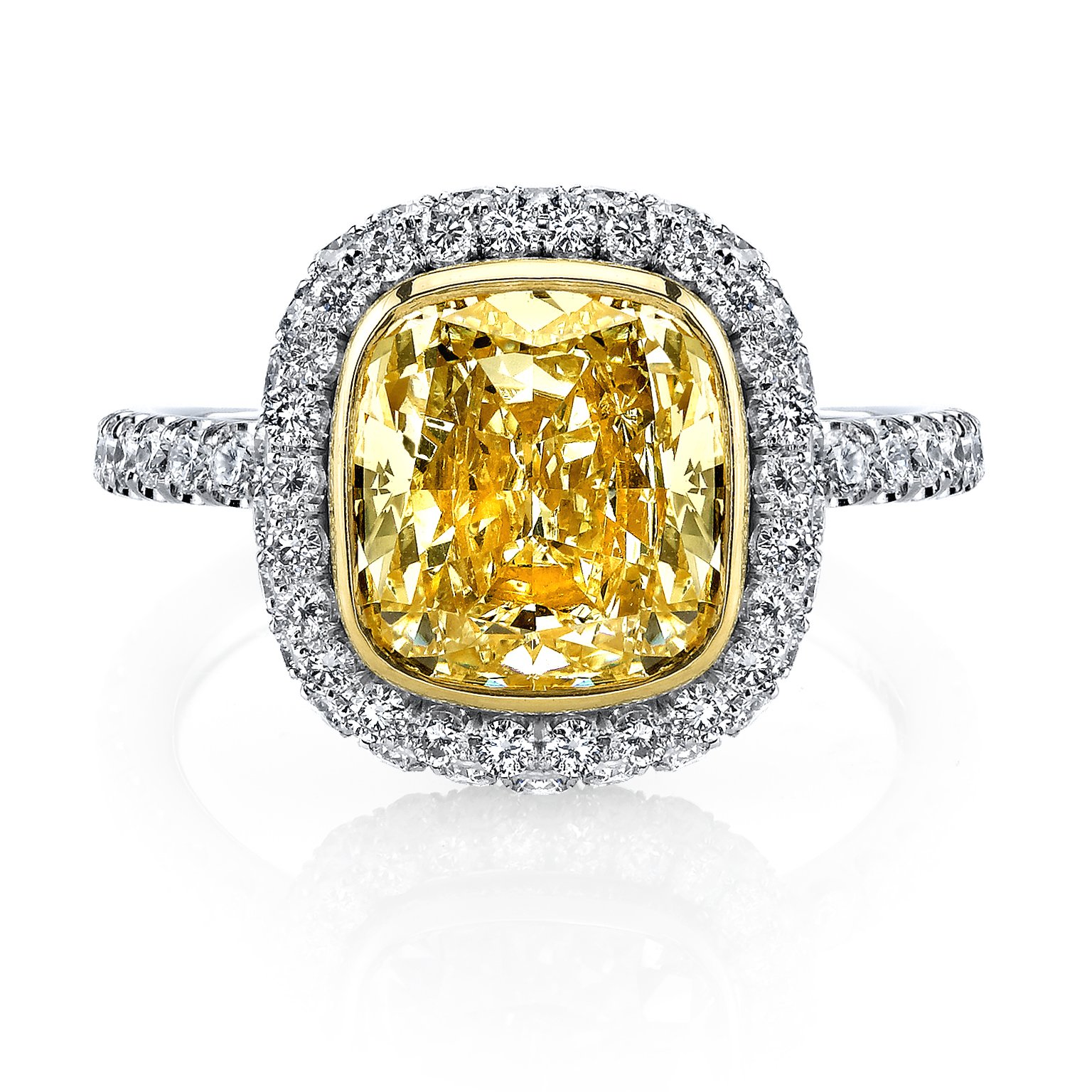 A white gold diamond halo ring with yellow diamond center stone