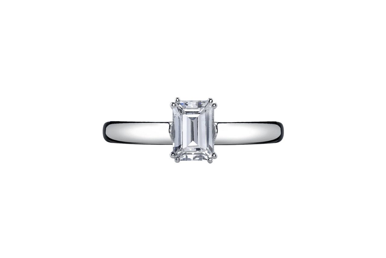 A solitaire engagement ring with an emerald cut stone.