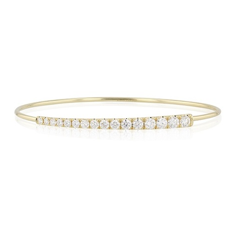 A yellow gold bangle, adorned with round cut diamonds.