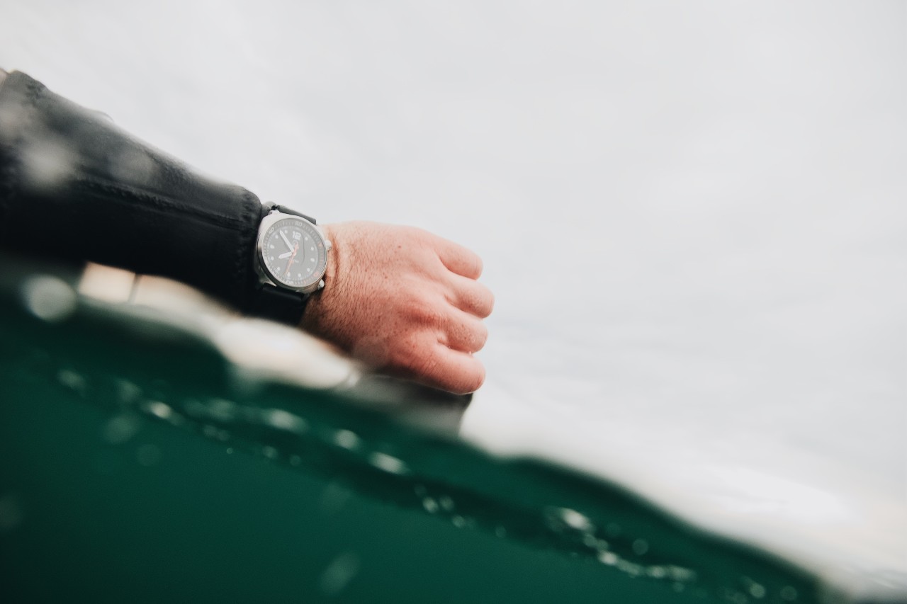 Surfer in the water wearing a watch with their wet suit