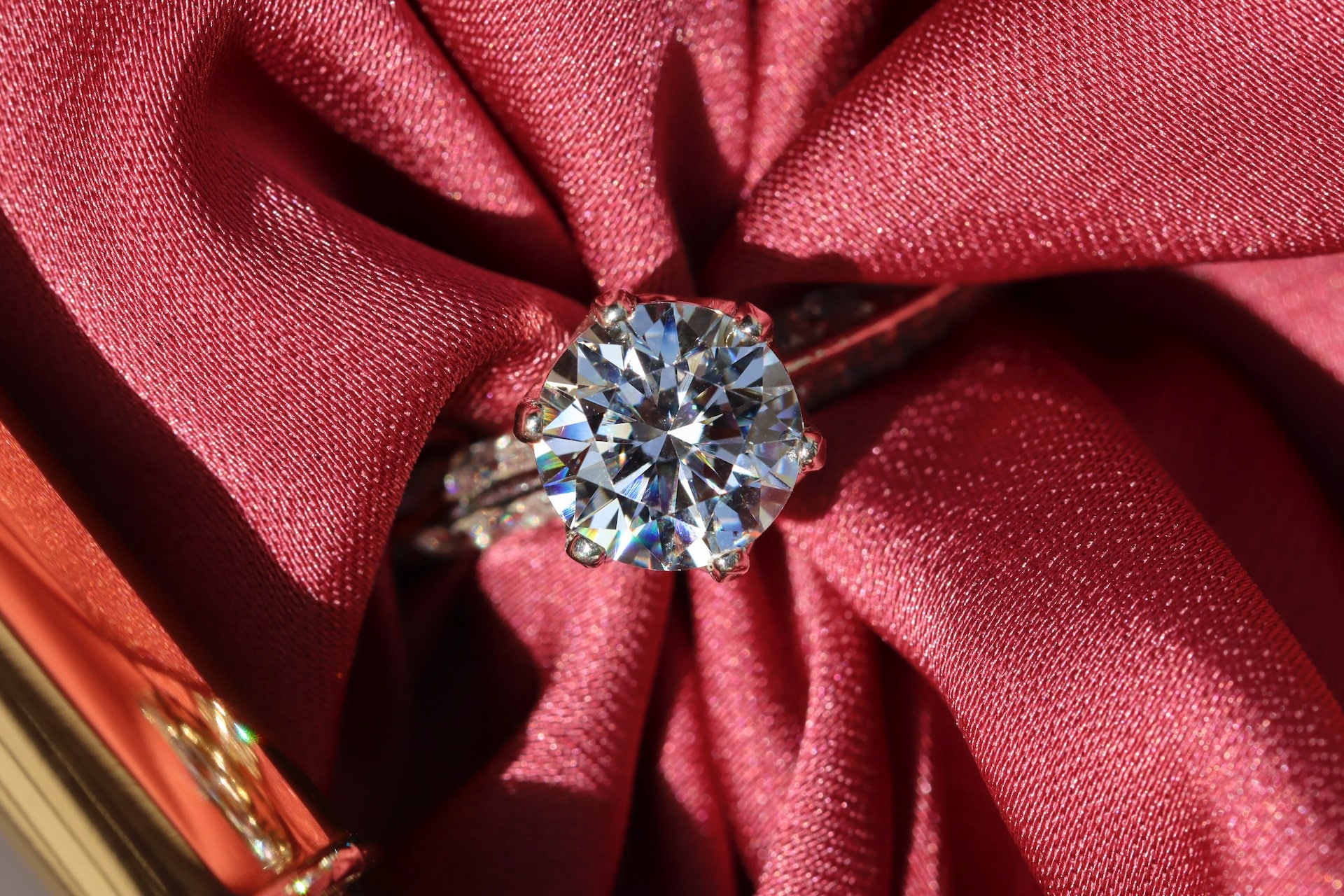 a diamond ring on a red background