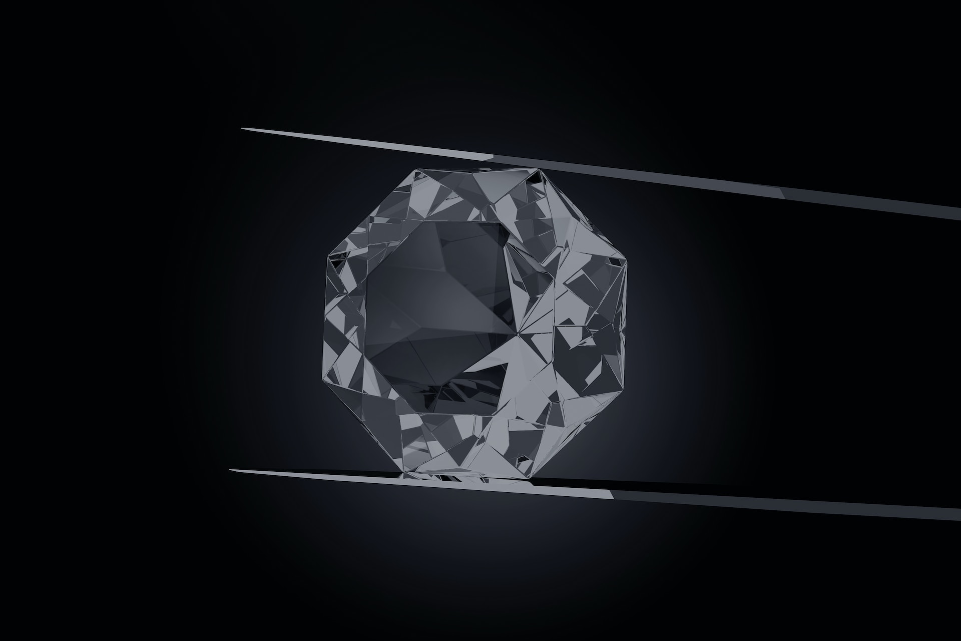 a diamond held between tongs on a black background