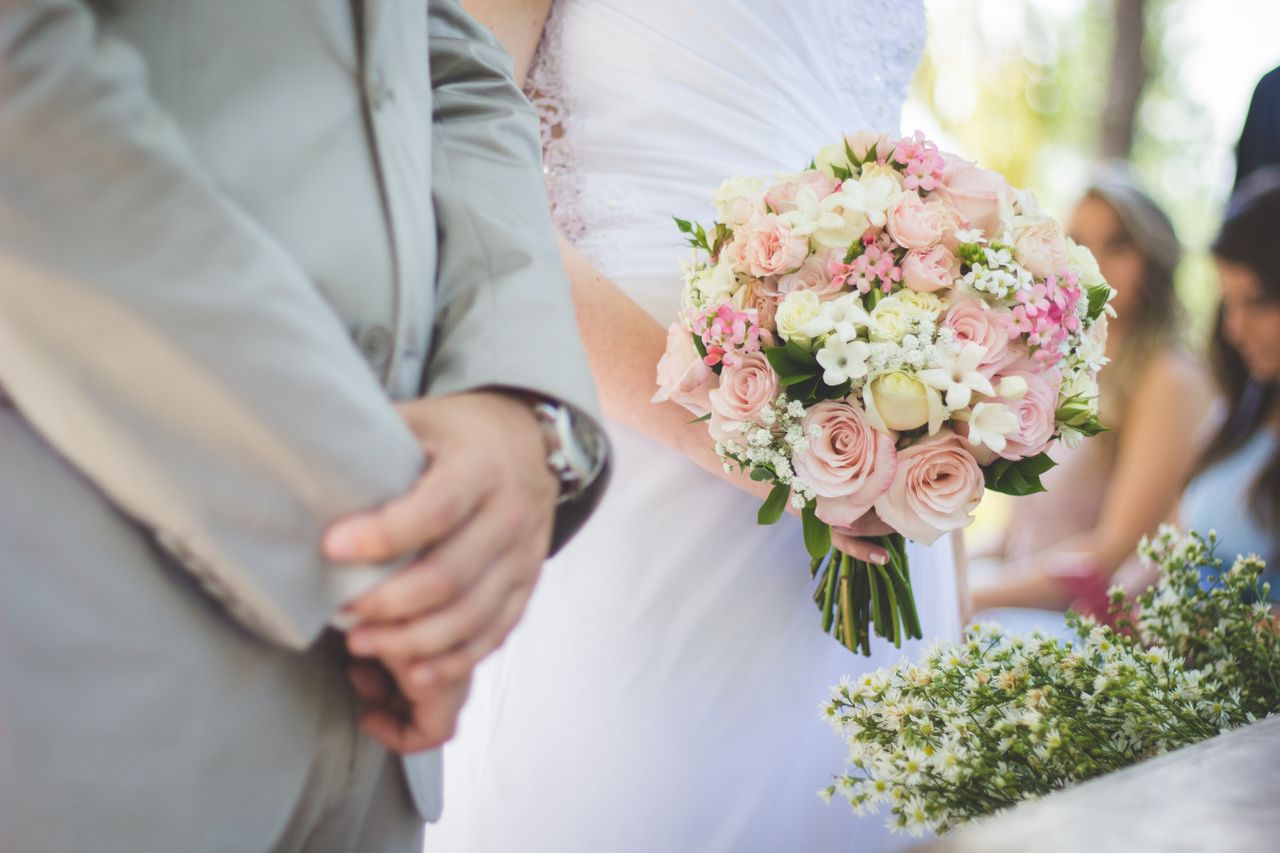 close up image of a bride and groom standing at the altar