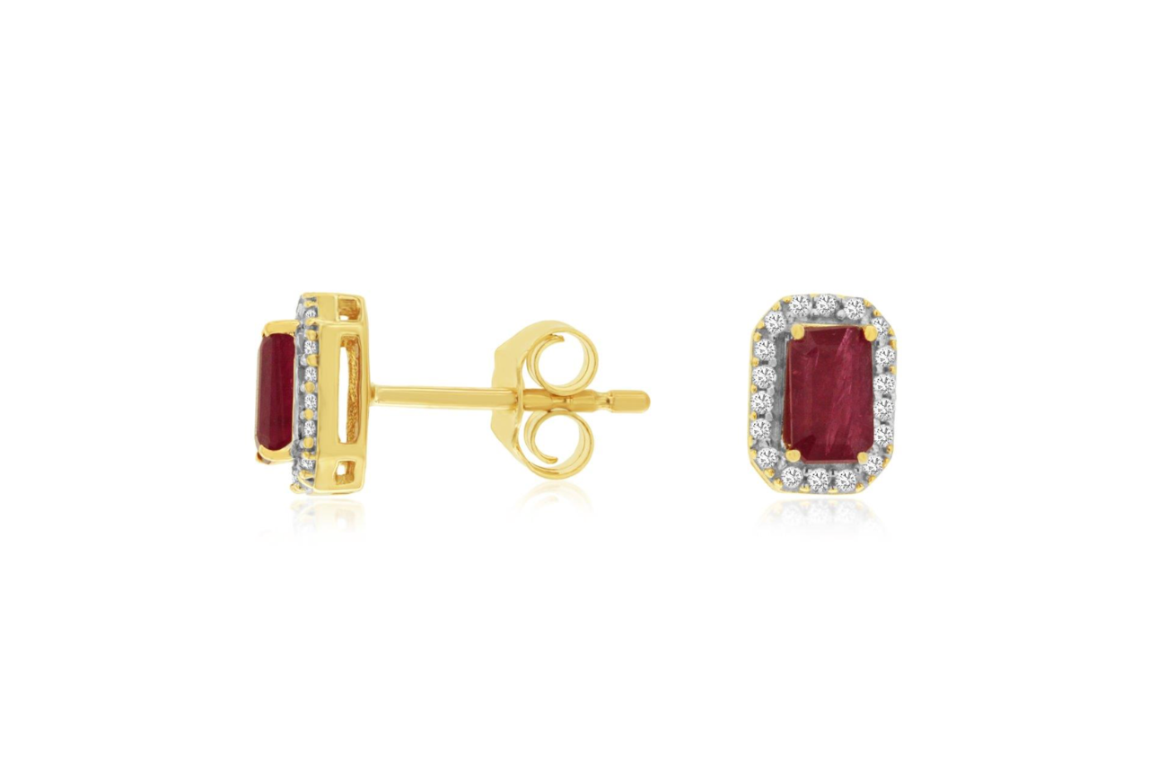 A pair of emerald cut ruby stud earrings with diamond halos.