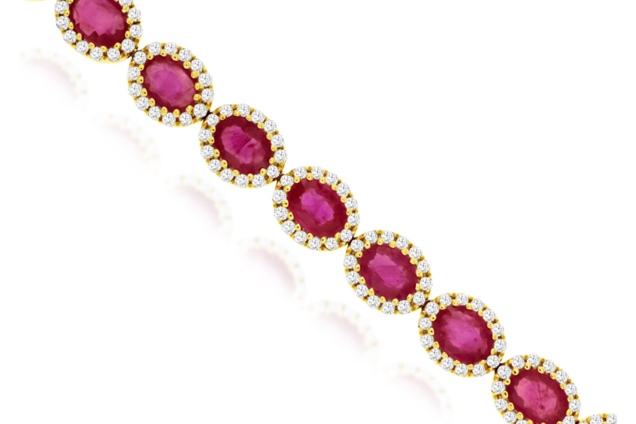 A yellow gold ruby and diamond halo bracelet.