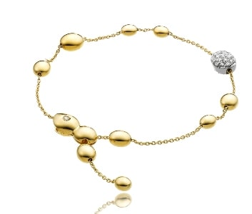 A Chimento bracelet features gold bubble shapes with a diamond-adorned bubble.