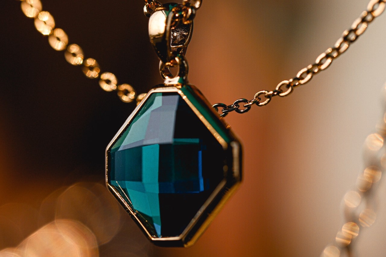 a large gemstone and rose gold pendant