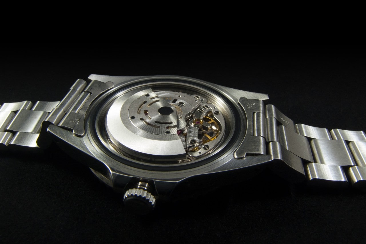 the open back of a watch revealing its movement