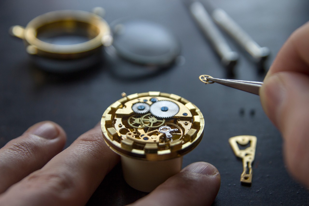 A horologist works on a watch’s interior.