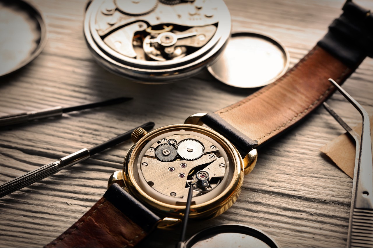 A watchmaker’s workstation with a watch and his tools.