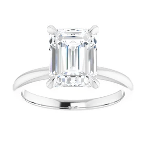 an emerald-cut diamond solitaire engagement ring with a platinum setting.