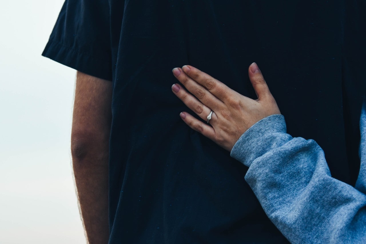 woman with solitaire engagement ring