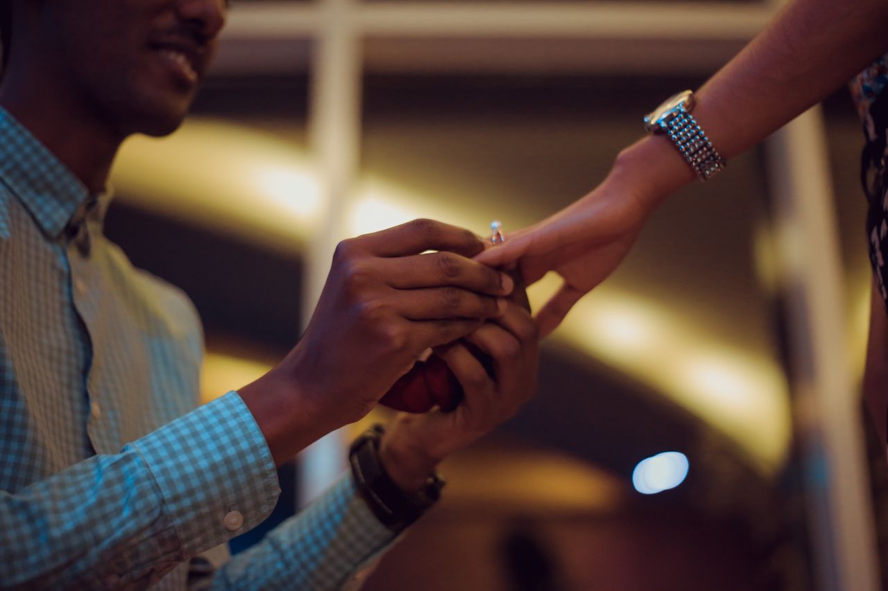 man proposing to woman with engagement ring