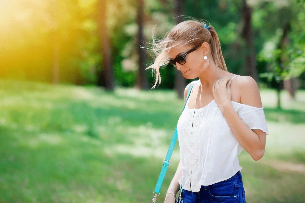 lady wearing luxury earrings and walking in the park