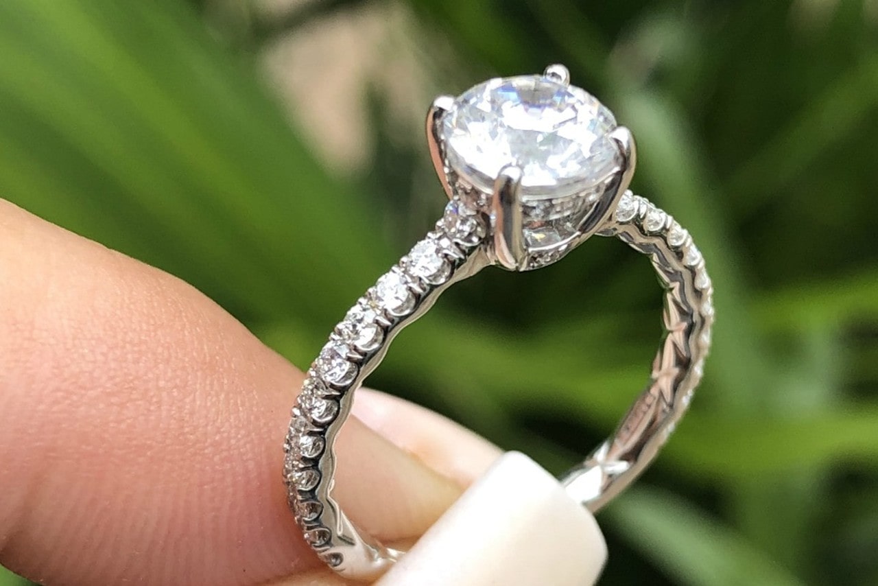 Woman’s fingers holding a diamond engagement ring