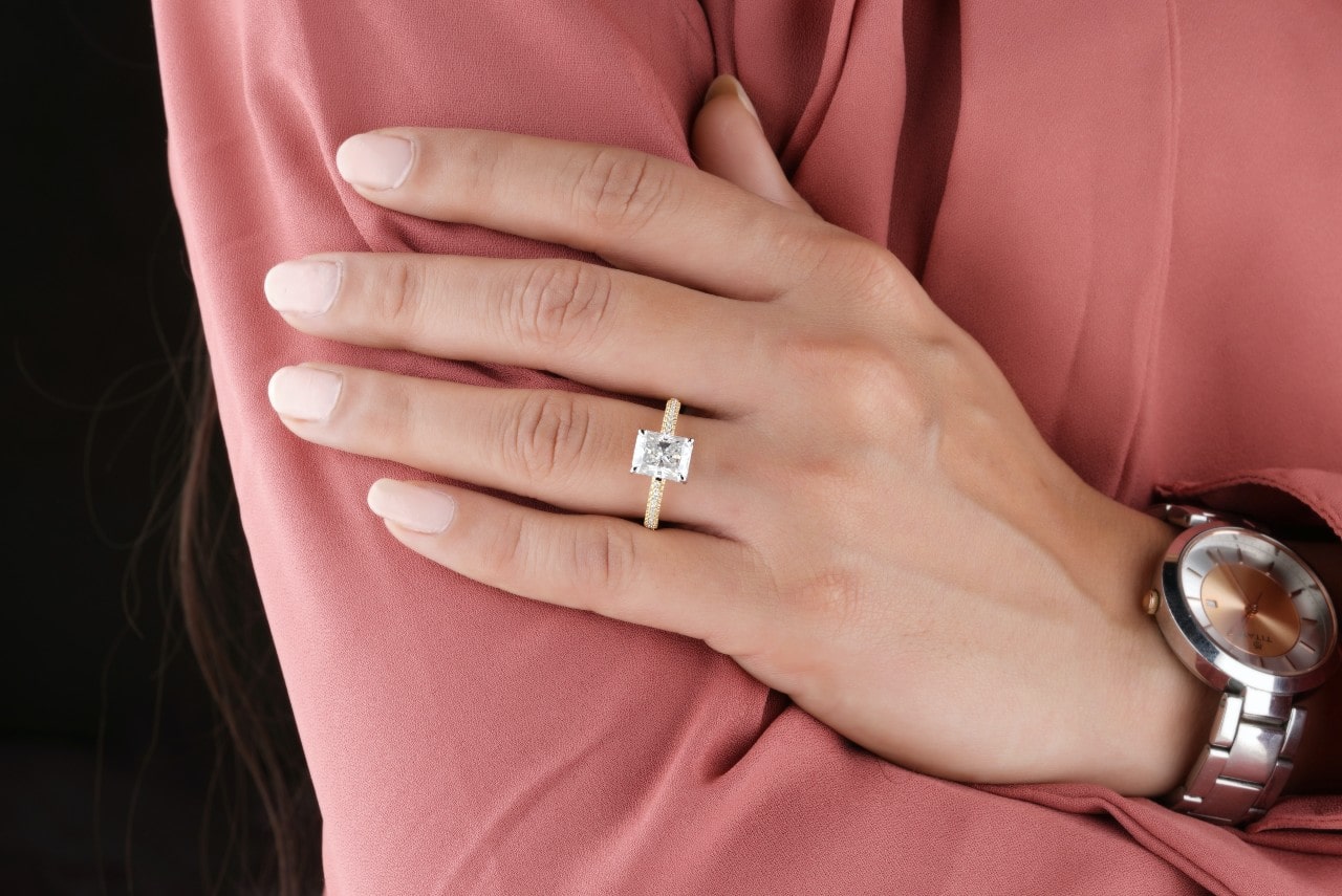 a lady wearing a luxury watch and an engagement ring